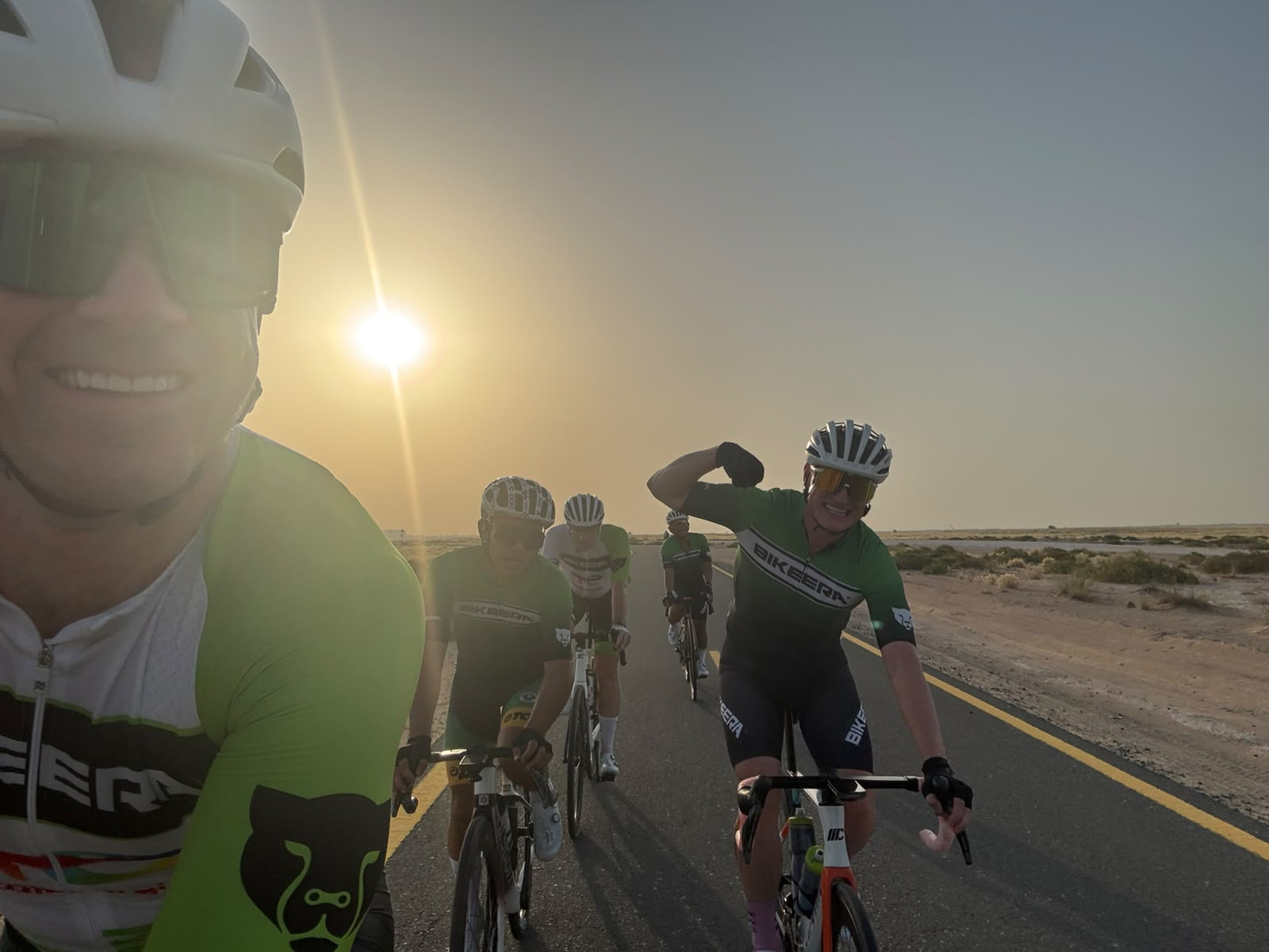 Clyde Rosanowski road cycling with a group at sunrise